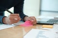 Man writing reminder on sticky note. male freelancer student working organizing plan at workplace Royalty Free Stock Photo