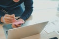 Man writing reminder on sticky note. male freelancer student working organizing plan at workplace Royalty Free Stock Photo