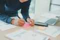 Man writing reminder on sticky note. male freelancer student working organizing plan at workplace Royalty Free Stock Photo