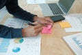 Man writing reminder on sticky note. male freelancer student working organizing plan at workplace Royalty Free Stock Photo