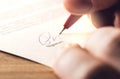 Man writing signature with pen on paper. Royalty Free Stock Photo