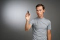 Man writing something with marker on glass board. Royalty Free Stock Photo