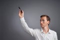 Man writing something with marker on glass board. Royalty Free Stock Photo