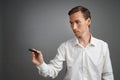 Man writing something with marker on glass board. Royalty Free Stock Photo