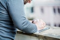 Man writing something on a notebook - close up side view