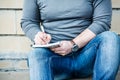 Man writing something on a notebook