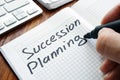 Man is writing succession planning. Royalty Free Stock Photo