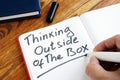 Man is writing Thinking Outside of The Box Royalty Free Stock Photo