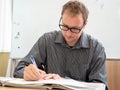 A man writing up paperwork at work. Royalty Free Stock Photo