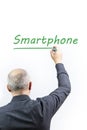 Man writing the word Smartphone on a white background with a green pen