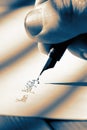 Man writing yours faithfully on the bottom of a letter with a fountain pen. Royalty Free Stock Photo