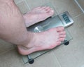 Man& x27;s feet on weight scale - Alert