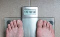 Man& x27;s feet on weight scale - Time for gym