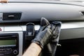 Man& x27;s hand in black glove cleaning car interior, dashboard and leather seats with microfiber cloth Royalty Free Stock Photo