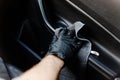 Man& x27;s hand in black glove cleaning car interior, dashboard and leather seats with microfiber cloth Royalty Free Stock Photo