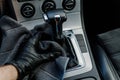Man& x27;s hand in black glove cleaning car interior, dashboard and leather seats with microfiber cloth Royalty Free Stock Photo