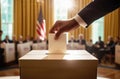 A man& x27;s hand drops his vote into the ballot box. American flags in the background, blurred background. Voting for Royalty Free Stock Photo