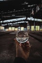 Man& x27;s hand holding a lensball inside a building.