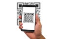 Man& x27;s hand holding smartphone scanning QR code on white background