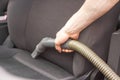Man& x27;s hand using vacuum cleaner in car. Portable car hoover with tube and hose at work. Cleaning of interior, seats. Royalty Free Stock Photo