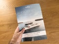 man's hand holds a glossy brochure featuring cruises offered by Croisi Royalty Free Stock Photo