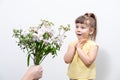 a man& x27;s hand holds out a bouquet of white flowers to a cute little girl Royalty Free Stock Photo