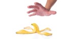 Man's hand reaching for a peeled banana skin Royalty Free Stock Photo