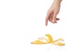 Man's hand reaching for a peeled banana skin Royalty Free Stock Photo