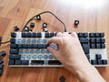 Man& x27;s hand remove each keycap and cleaning mechanical keyboard