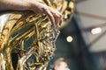 Man playing a brass musical instrument tuba in an orchestra during a ceremony