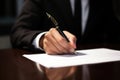 Man& x27;s hand signing a major financial contract with luxury pens. Male client putting signature at document in office Royalty Free Stock Photo