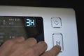 man& x27;s hand on the start button of the washing machine Royalty Free Stock Photo