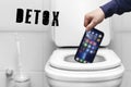 a man's hand throws out the phone dependence on social networks and a smartphone, throws the toilet into the trash