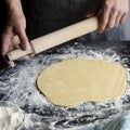 The man& x27;s hands prepare the dough for the preparation of pizza and home baking Royalty Free Stock Photo