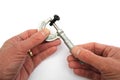 Man& x27;s hands seen using a vintage imperial micrometer to measure Royalty Free Stock Photo