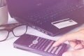 Man's hands using calculator for online shopping and credit card