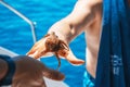 Man on a yacht caught an octopus from the sea. Royalty Free Stock Photo