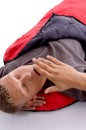 Man yawning in sleeping bag Royalty Free Stock Photo