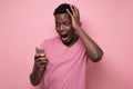 Man yelling at mobile phone receiving news that he lost his money Royalty Free Stock Photo