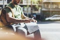 Man with yellow backpack holding smartphone, tourist looking map city on background taxi, hipster planning route using in hands Royalty Free Stock Photo