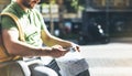 Man with yellow backpack holding smartphone, tourist looking map city on background taxi, hipster planning route using in hands Royalty Free Stock Photo