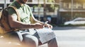 Man with yellow backpack holding smartphone, tourist looking map city on background taxi, hipster planning route using in hands Royalty Free Stock Photo