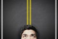 Man with yellow highway lines on the blackboard