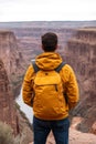 Man With Yellow Jacket And Backpack Exploring Scenic Canyon, Adventure And Exploration Concept. Royalty Free Stock Photo
