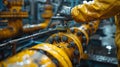 A man in a yellow jacket is working on a yellow pipe Royalty Free Stock Photo