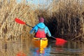 Man in a yellow kayak rowing through the aisle in a dry cane