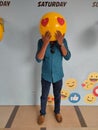 Man with yellow love smiley emoji hands on mouth