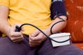 Man in yellow shirt is checking his blood pressure Royalty Free Stock Photo