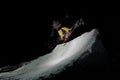 Man jumping on a snowboard against the dark sky Royalty Free Stock Photo