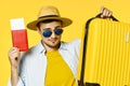 A man with a yellow suitcase and red passport glasses Royalty Free Stock Photo